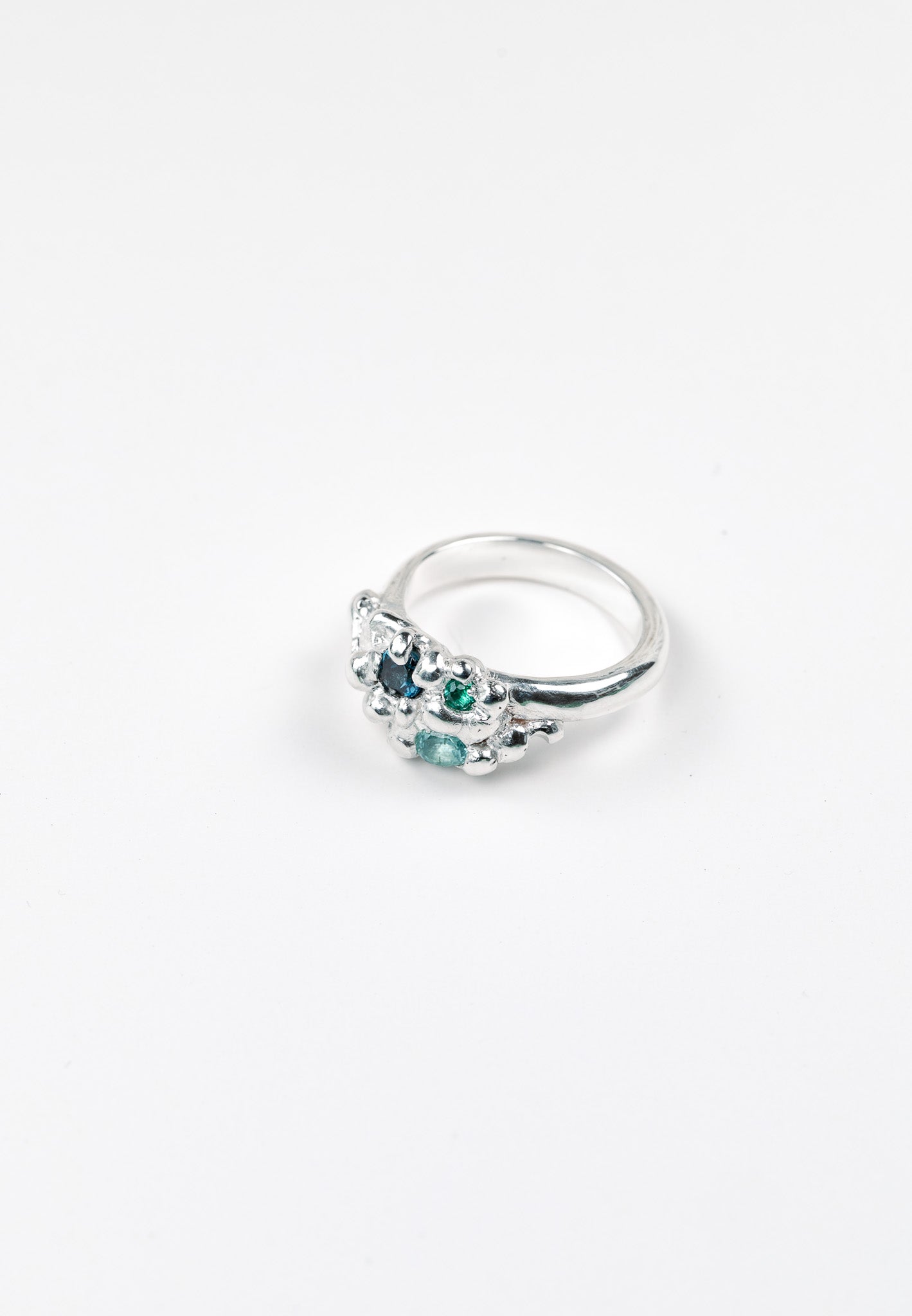 Organic sculptural silver ring with scattered gemstones