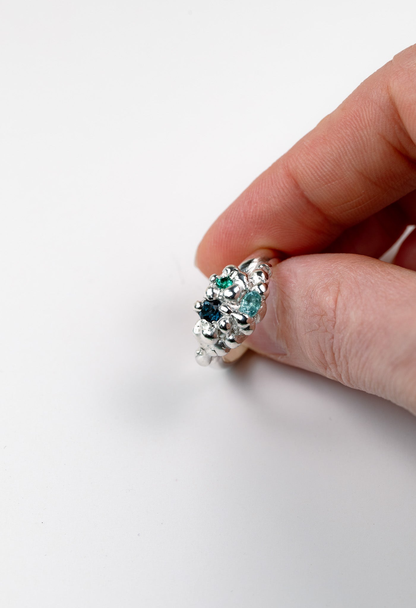 Organic sculptural silver ring with scattered gemstones