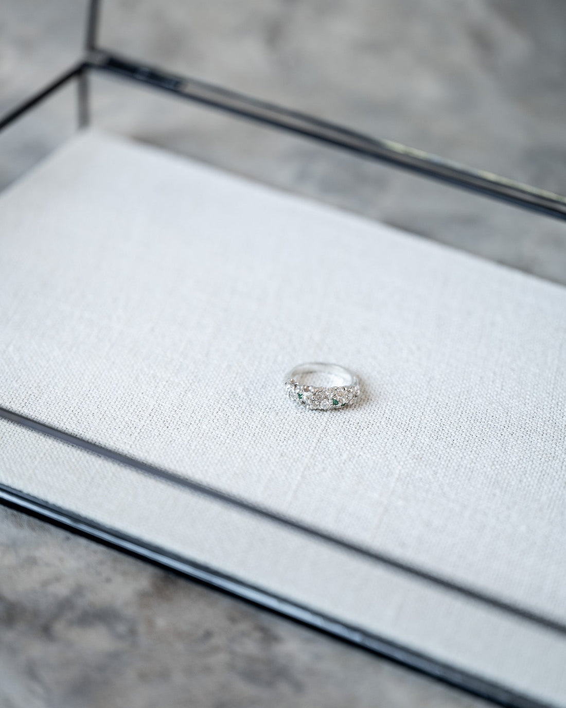 Silver ring on a textured wooden surface