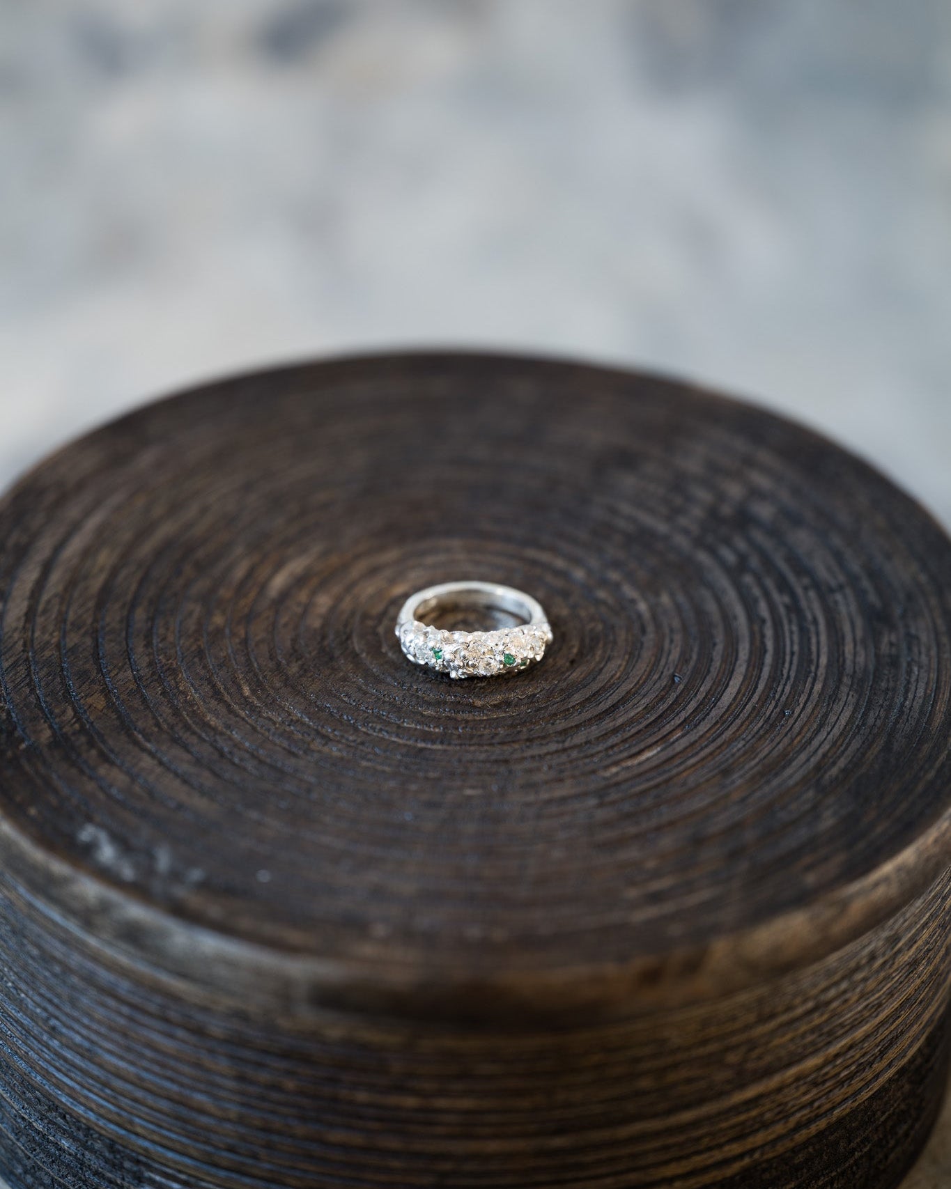 Silver ring on a textured wooden surfaceshop_this_look_amDhCa