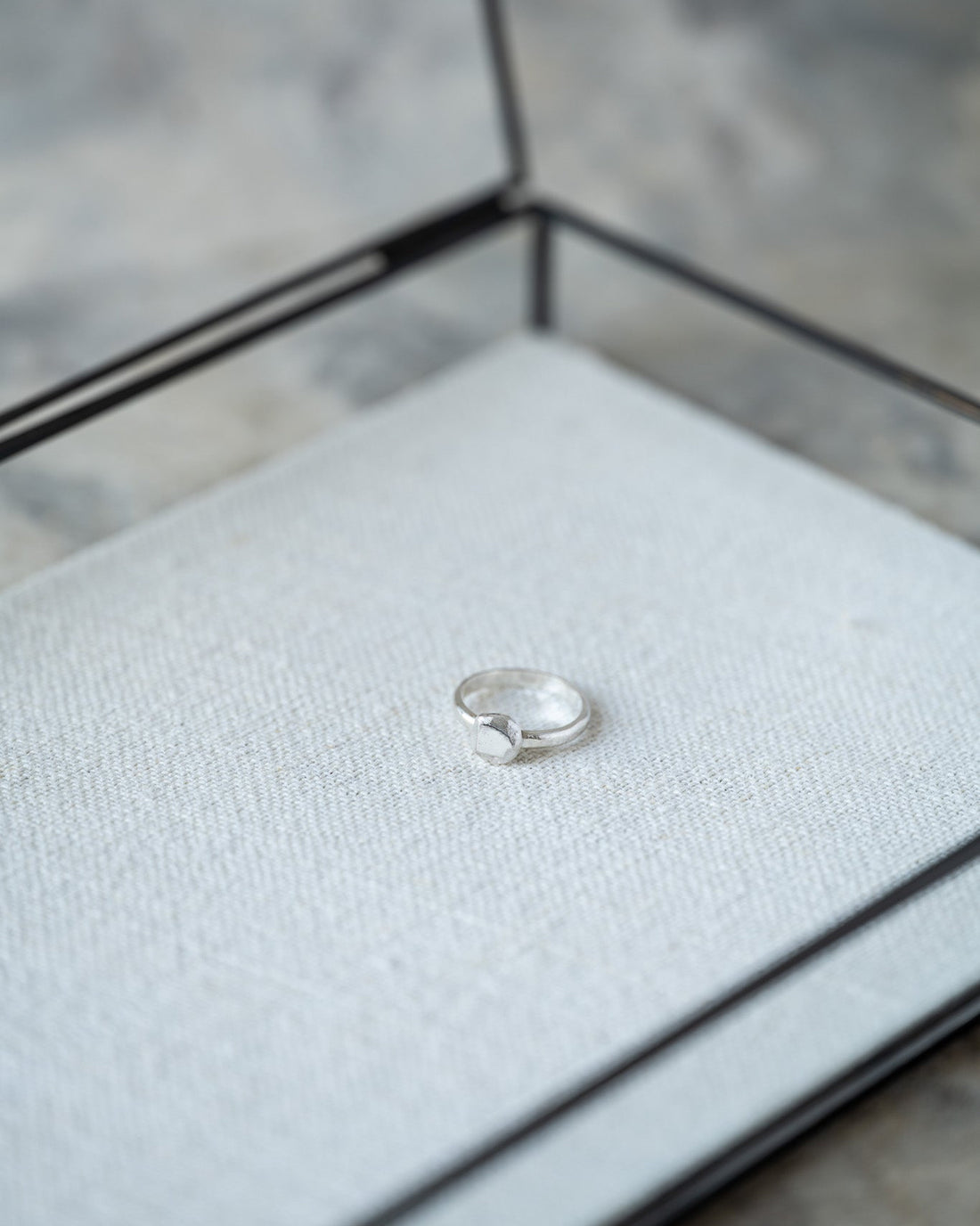 Silver ring in a jewelry box with a blurred background
