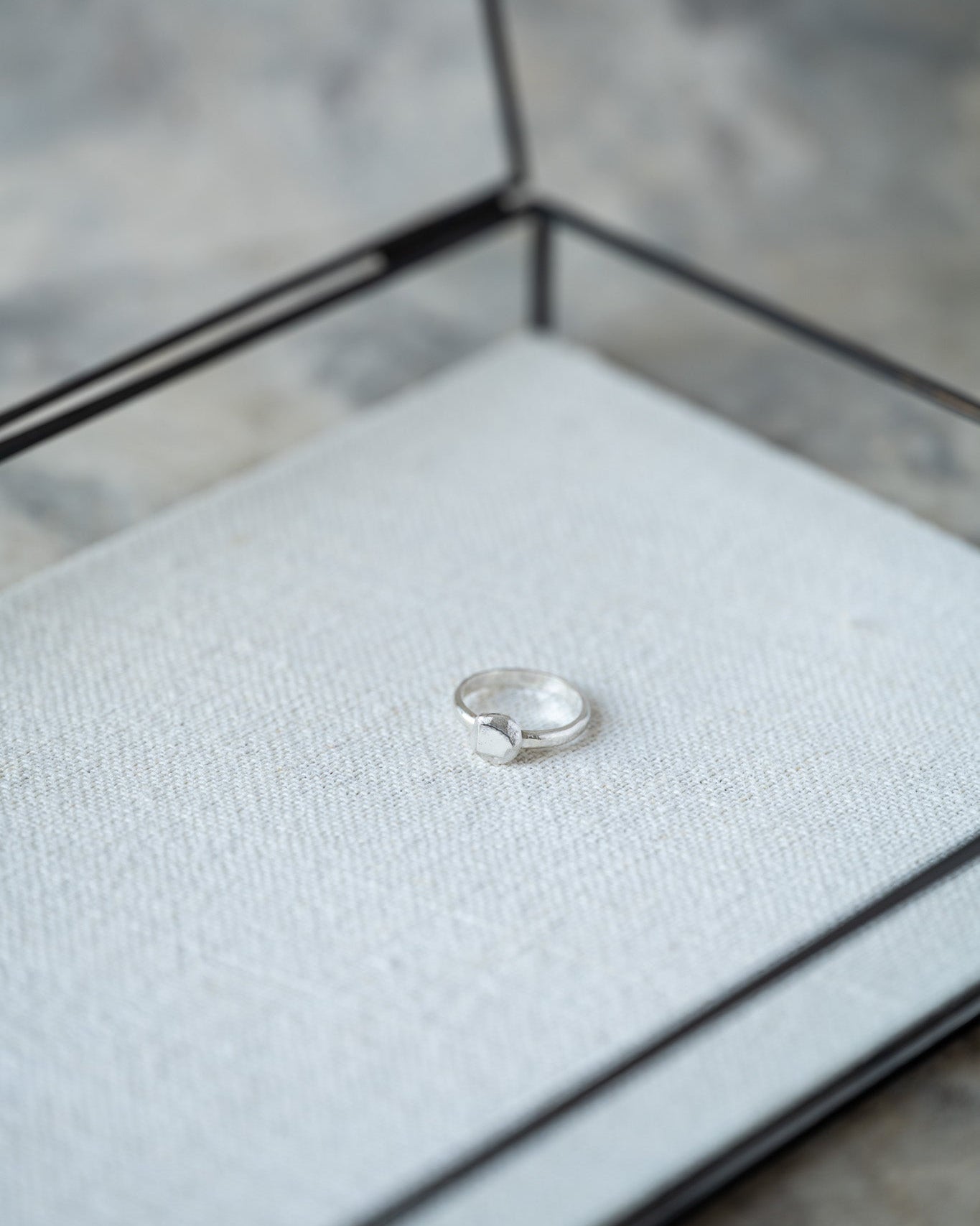Silver ring in a jewelry box with a blurred background