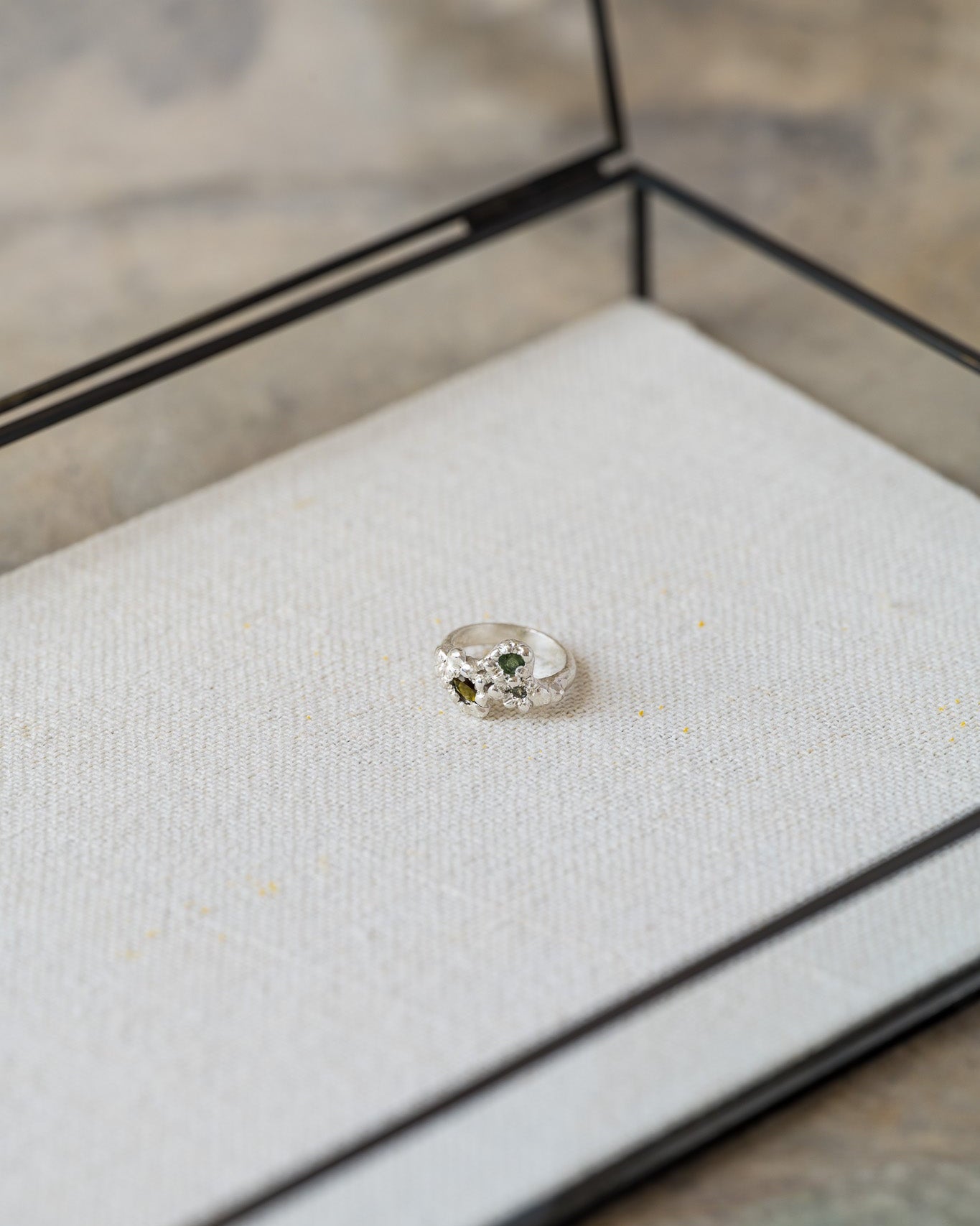 Diamond in a jewelry box on a textured surface