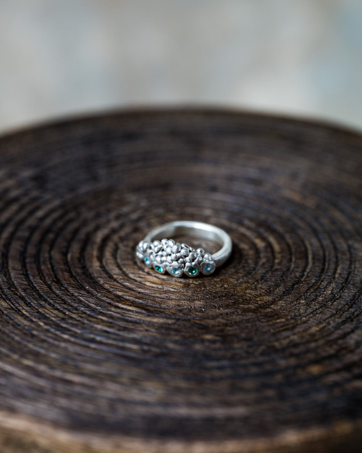 Handmade Volcanic Lake silver ring with organic rocky texture and small blue and green gemstones by Mintuchi