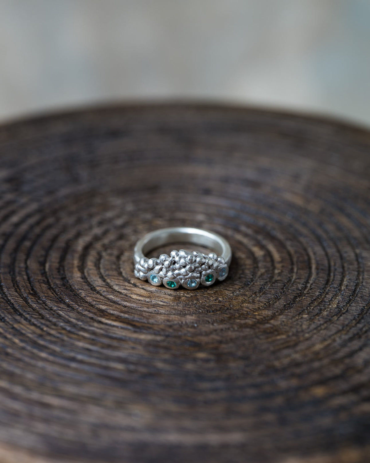 Handmade Volcanic Lake silver ring with organic rocky texture and small blue and green gemstones by Mintuchi