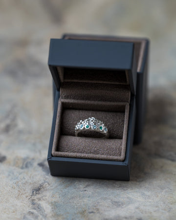 Handmade Volcanic Lake silver ring with organic rocky texture and small blue and green gemstones by Mintuchi.
