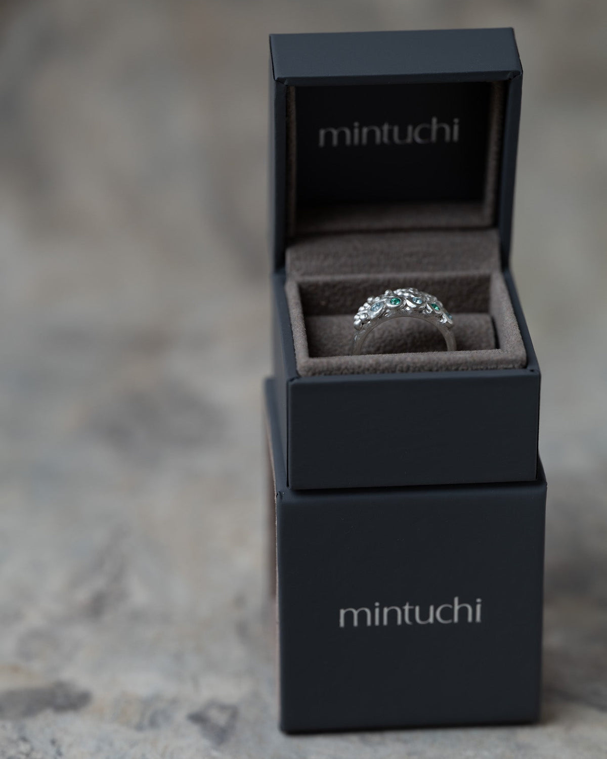 Handmade Volcanic Lake silver ring with organic rocky texture and small blue and green gemstones by Mintuchi