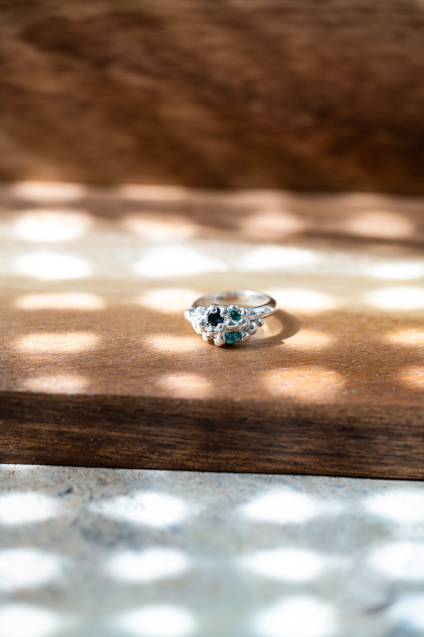 Organic sculptural silver ring with scattered gemstones