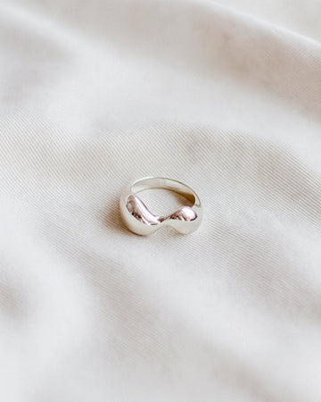Silver ring on a light fabric background